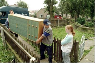 The Open Door team delivering a chest of drawers to a home